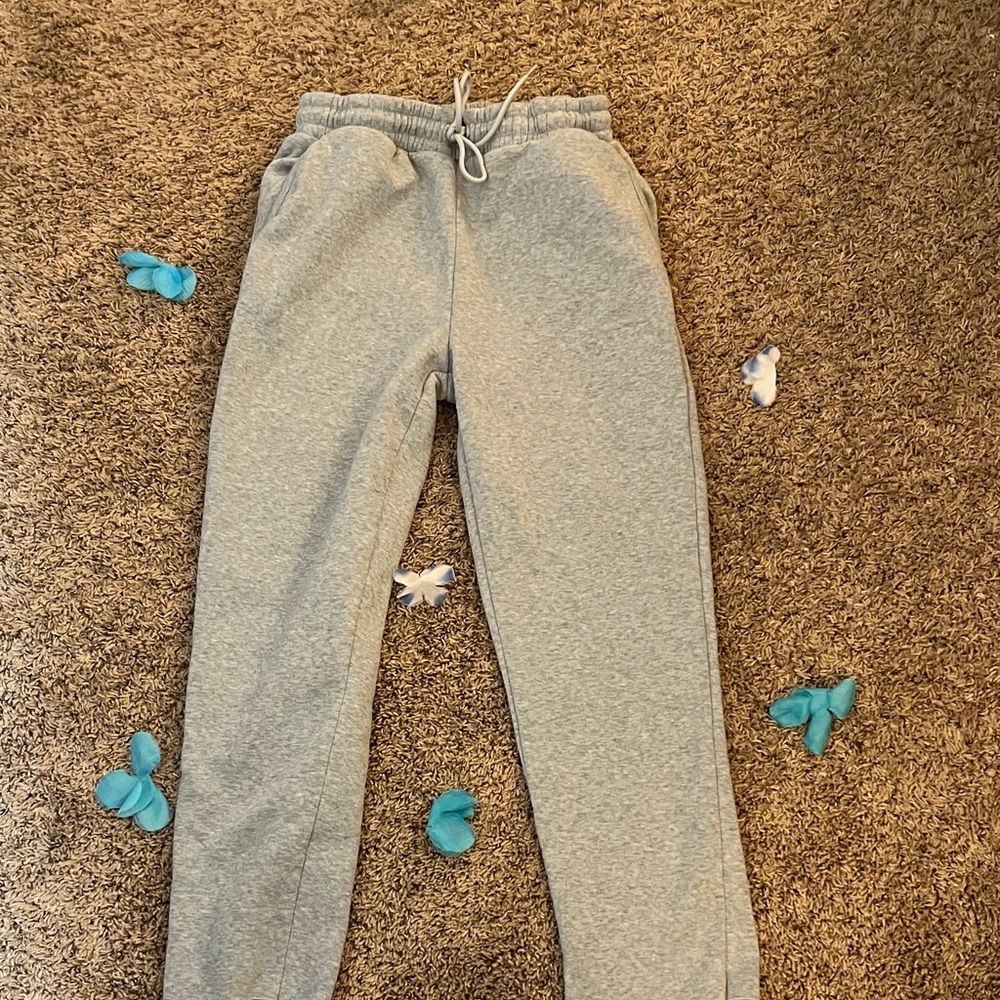 A light gray pair of baggy-ish sweatpants. No cuff with pocket on back